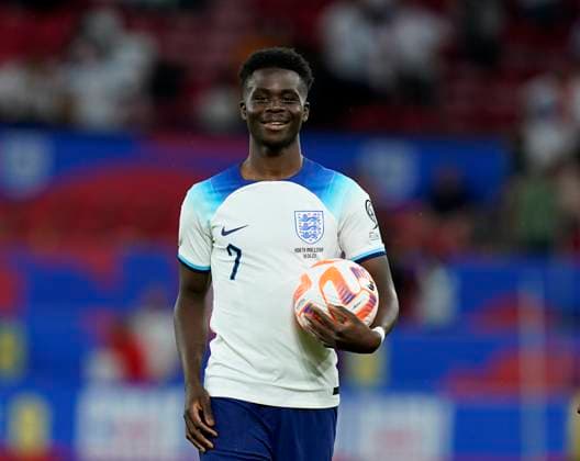 Manchester, England, 19th June 2023. Bukayo Saka of England celebrates at the final whistle with the match ball during the UEFA European Championship, EM, Europameisterschaft Qualifying match at Old Trafford, Manchester. Picture credit should read: Andrew Yates Sportimage EDITORIAL USE ONLY. No use with unauthorised audio, video, data, fixture lists, club league logos or live services. Online in-match use limited to 120 images, no video emulation. No use in betting, games or single club league player publications. SPI-2485-0107