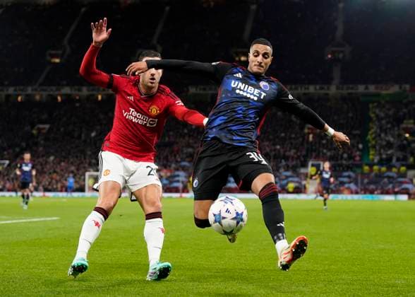 Manchester, England, 24th October 2023. Diogo Dalot of Manchester United, ManU tussles with Elias Achouri of FC Copenhagen during the UEFA Champions League match at Old Trafford, Manchester. Picture credit should read: Andrew Yates Sportimage EDITORIAL USE ONLY. No use with unauthorised audio, video, data, fixture lists, club league logos or live services. Online in-match use limited to 120 images, no video emulation. No use in betting, games or single club league player publications. SPI-2672-0049