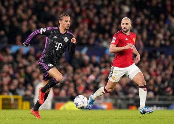 Manchester, England, 12th December 2023. Leroy Sanà of Bayern Munich and Sofyan Amrabat of Manchester United, ManU during the UEFA Champions League match at Old Trafford, Manchester. Picture credit should read: Andrew Yates Sportimage EDITORIAL USE ONLY. No use with unauthorised audio, video, data, fixture lists, club league logos or live services. Online in-match use limited to 120 images, no video emulation. No use in betting, games or single club league player publications. SPI-2800-0031