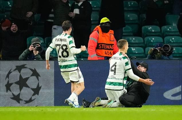 A Celtic fans runs on to the pitch to celebrate with Gustaf Lagerbielke of Celtic while Lagerbielke celebrates scoring to give Celtic a 2-1 lead. Celtic v Feyenoord, UEFA Champions League, Group E, Football, Celtic Park, Glasgow, UK - 13 Dec 2023 EDITORIAL USE ONLY No use with unauthorised audio, video, data, fixture lists, club league logos or live services. Online in-match use limited to 120 images, no video emulation. No use in betting, games or single club league player publications. Copyright: xStuartxWallace Shutterstockx 14254242bc