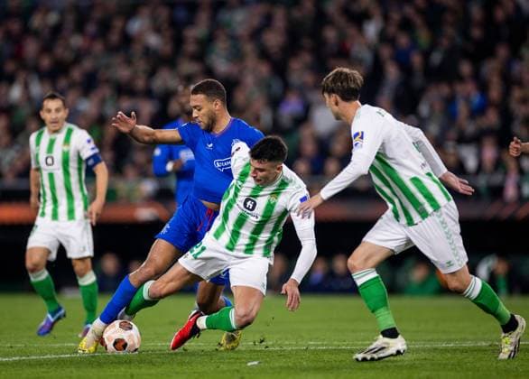 Rangers Forward Cyriel Dessers in action with Marc Roca of Real Betis during the Europa League Group C match at the Estadio Benito Villamarin, Seville. Real Betis v Rangers, UEFA Europa League, Group C, Football, Benito VillamaroÆ?Ã?Ân Stadium, Seville, Spain - 14 Dec 2023 EDITORIAL USE ONLY No use with unauthorised audio, video, data, fixture lists, club league logos or live services. Online in-match use limited to 120 images, no video emulation. No use in betting, games or single club league player publications. Copyright: xKirkxO Rourke RangersxFC Shutterstockx 14257803bz