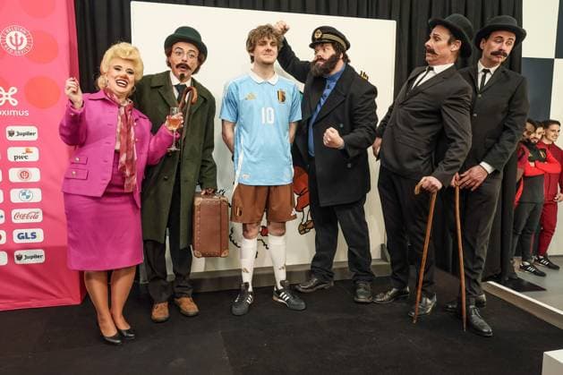 A model showing the away outfit referencing to Kuifje-Tintin, is surrounded by characters from the comic book series, such as singer Bianca Castafiore, Professor Calculus (Tournesol-Zonnebloem), Captain Haddock and detectives Thomson and Thompson (Jansen en Janssen - Dupont et Dupond) during a press conference, PK, Pressekonferenz of Belgian national soccer team Red Devils to present the new shirts for the UEFA EURO, EM, Europameisterschaft,Fussball 2024 European Championship, EM, Europameisterschaft Thursday 14 March 2024, at the Musee Herge in Louvain-la-Neuve. The new outfit, with light blue shirt with white collar, combined with brown shorts, refers to the iconic outfit of Kuifje - Tintin, the world-famous Belgian reporter-adventurer from the Herge comic books. BRUNOxFAHY x89127174x