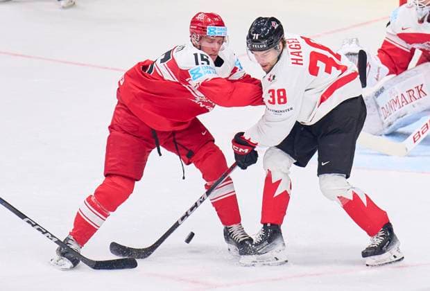 Brandon Hagel CAN 38 compete, fight for the puck against, Matias Lassen, DEN 15 in the preliminary round match DENMARK - CANADA of the IIHF Ice hockey, Eishockey World Championship, WM, Weltmeisterschaft Group A in Prague, Czechia, May 12, 2024, Season 2023 2024