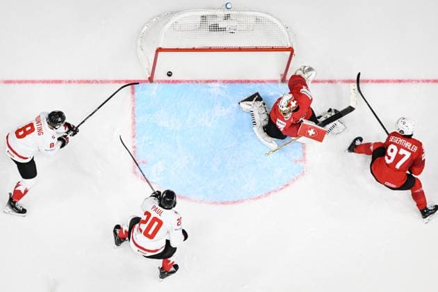 Nick Paul of Canada, 2nd left, scores a goal past goalkeeper of Switzerland Leonardo Genoni, 2nd right, during the 2024 IIHF World Championship, WM, Weltmeisterschaft group A match Switzerland vs Canada in Prague, Czech Republic, May 19, 2024. At left is Michael Bunting of Canada, at right is Jonas Siegenthaler of Switzerland. (CTKxPhoto VitxSimanek) CTKPhotoP2024051908075 CTKPhotoP2024051908075