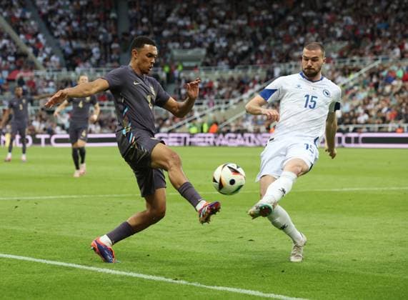 Newcastle Upon Tyne, England, 3rd June 2024. Trent Alexander-Arnold (L) of England in action with Nihad Mujakic of Bosnia-Herzegovina during the International Friendly, Länderspiel, Nationalmannschaft match between England and Bosnia-Herzegovina at St. James Park, Newcastle Upon Tyne. Picture credit should read: Nigel Roddis Sportimage EDITORIAL USE ONLY. No use with unauthorised audio, video, data, fixture lists, club league logos or live services. Online in-match use limited to 120 images, no video emulation. No use in betting, games or single club league player publications. SPI-3178-0036
