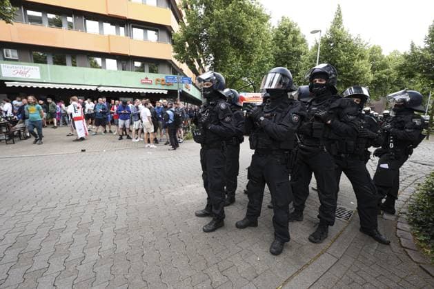 Police in riot gear near the the main square, Gelsenkirchen, Germany keep an eye on England fans Serbia v England, UEFA European Championship, EM, Europameisterschaft 2024, Group C, Football, Arena Aufschalke, Gelsenkirchen, Germany - 16 Jun 2024 EDITORIAL USE ONLY No use with unauthorised audio, video, data, fixture lists, club league logos or live services. Online in-match use limited to 120 images, no video emulation. No use in betting, games or single club league player publications. Copyright: xPaulxCurrie Shutterstockx 14541951ax