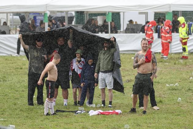 A general view of England fans in the fan zone sheltering from the rain at Trabrennbahn, Gelsenkirchen, Germany Serbia v England, UEFA European Championship, EM, Europameisterschaft 2024, Group C, Football, Arena Aufschalke, Gelsenkirchen, Germany - 16 Jun 2024 EDITORIAL USE ONLY No use with unauthorised audio, video, data, fixture lists, club league logos or live services. Online in-match use limited to 120 images, no video emulation. No use in betting, games or single club league player publications. Copyright: xPaulxCurrie Shutterstockx 14541951cg