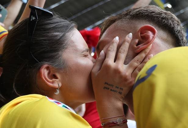 Denis Dragus of Romania kisses his wife after the match Romania v Ukraine, UEFA European Championship, EM, Europameisterschaft 2024, Group E, Football, Munich Football Arena, Munich, Germany, 17 Jun 2024 EDITORIAL USE ONLY No use with unauthorised audio, video, data, fixture lists, club league logos or live services. Online in-match use limited to 120 images, no video emulation. No use in betting, games or single club league player publications. Copyright: xMichaelxZemanek Shutterstockx 14539636cl