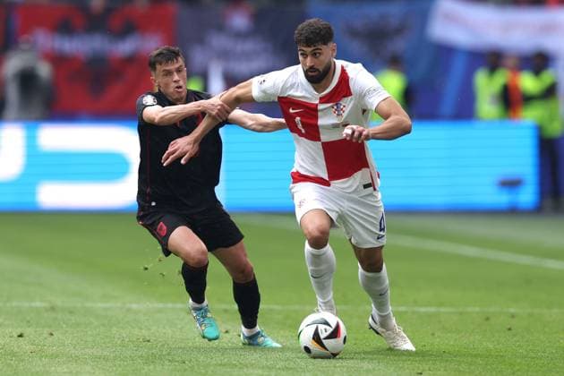 Jasir Asani of Albania and Josko Gvardiol of Croatia Croatia v Albania, UEFA European Championship, EM, Europameisterschaft 2024, Group B, Football, Volksparkstadion, Hamburg, Germany, 19 Jun 2024 EDITORIAL USE ONLY No use with unauthorised audio, video, data, fixture lists, club league logos or live services. Online in-match use limited to 120 images, no video emulation. No use in betting, games or single club league player publications. Copyright: xPaulxCurrie Shutterstockx 14543648am