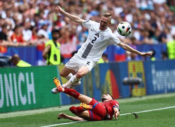 Zan Karnicnik of Slovenia is fouled by Filip Mladenovic of Serbia Slovenia v Serbia, UEFA European Championship, EM, Europameisterschaft 2024, Group C, Football, Munich Football Arena, Munich, Germany, 20 Jun 2024 EDITORIAL USE ONLY No use with unauthorised audio, video, data, fixture lists, club league logos or live services. Online in-match use limited to 120 images, no video emulation. No use in betting, games or single club league player publications. Copyright: xMichaelxZemanek Shutterstockx 14543659ev