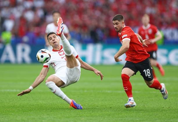 Jan Bednarek of Poland attempts to clear the ball whilst under pressure from Romano Schmid of Austria Poland v Austria, UEFA European Championship, EM, Europameisterschaft 2024, Group D, Football, Olympiastadion, Berlin, Germany, 21 Jun 2024 EDITORIAL USE ONLY No use with unauthorised audio, video, data, fixture lists, club league logos or live services. Online in-match use limited to 120 images, no video emulation. No use in betting, games or single club league player publications. Copyright: xKieranxMcManus Shutterstockx 14543876be