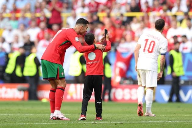 A young fan takes a selfie with Cristiano Ronaldo of Portugal during the match Turkiye v Portugal, UEFA European Championship, EM, Europameisterschaft 2024, Group F, Football, BVB Stadion, Dortmund, Germany, 22 Jun 2024 EDITORIAL USE ONLY No use with unauthorised audio, video, data, fixture lists, club league logos or live services. Online in-match use limited to 120 images, no video emulation. No use in betting, games or single club league player publications. Copyright: xPaulxCurrie Shutterstockx 14548034el