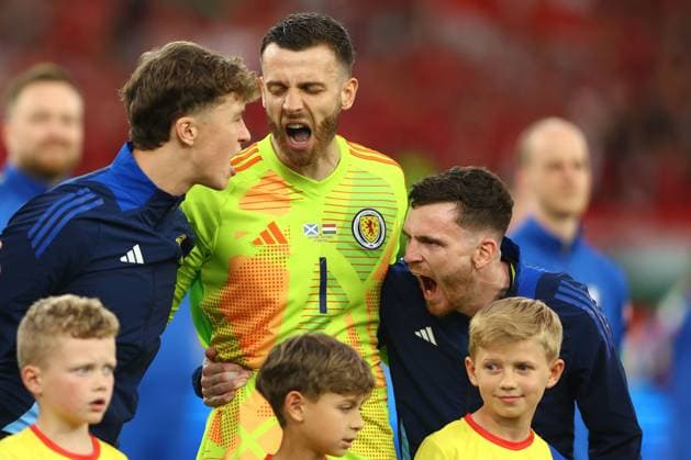 Andrew Robertson of Scotland (right), Angus Gunn of Scotland (centre) and Jack Hendry of Scotland (left) show passion before the match Scotland v Hungary, UEFA European Championship, EM, Europameisterschaft 2024, Group A, Football, Stuttgart Arena, Stuttgart, Germany, 23 Jun 2024 EDITORIAL USE ONLY No use with unauthorised audio, video, data, fixture lists, club league logos or live services. Online in-match use limited to 120 images, no video emulation. No use in betting, games or single club league player publications. Copyright: xKieranxMcManus Shutterstockx 14548072ag