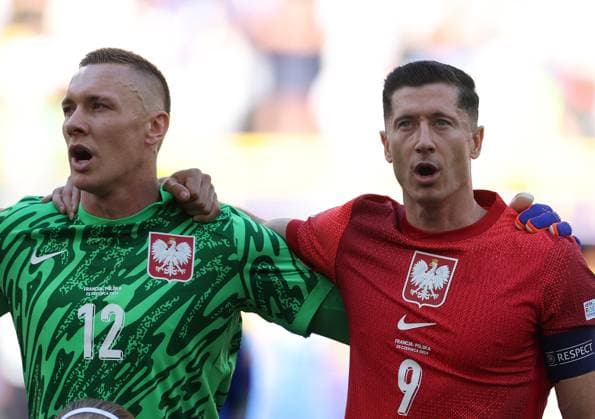 Lukasz Skorupski of Poland and Robert Lewandowski of Poland during the national anthem France v Poland, UEFA European Championship, EM, Europameisterschaft 2024, Group D, Football, BVB Stadion, Dortmund, Germany, 25 Jun 2024 EDITORIAL USE ONLY No use with unauthorised audio, video, data, fixture lists, club league logos or live services. Online in-match use limited to 120 images, no video emulation. No use in betting, games or single club league player publications. Copyright: xPaulxCurrie Shutterstockx 14555523ax