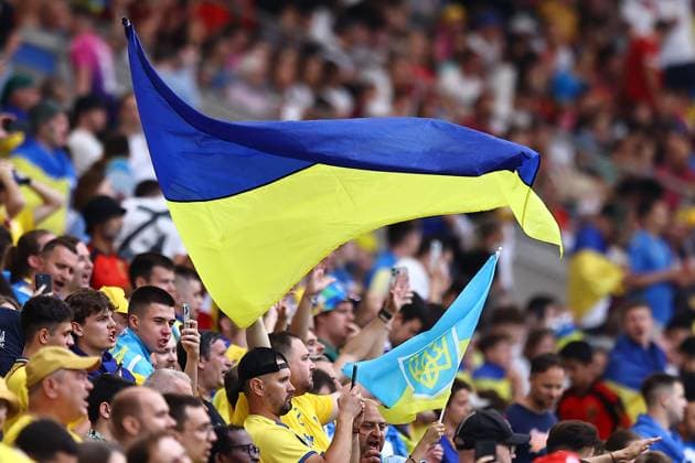 Ukraine fans wave flags in the stands Ukraine v Belgium, UEFA European Championship, EM, Europameisterschaft 2024, Group E, Football, Stuttgart Arena, Stuttgart, Germany - 26 Jun 2024 EDITORIAL USE ONLY No use with unauthorised audio, video, data, fixture lists, club league logos or live services. Online in-match use limited to 120 images, no video emulation. No use in betting, games or single club league player publications. Copyright: xMichaelxZemanek Shutterstockx 14555605j