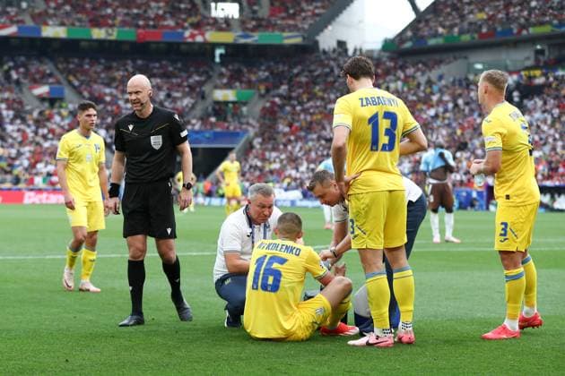 Vitaliy Mykolenko of Ukraine receives treatment Ukraine v Belgium, UEFA European Championship, EM, Europameisterschaft 2024, Group E, Football, Stuttgart Arena, Stuttgart, Germany - 26 Jun 2024 EDITORIAL USE ONLY No use with unauthorised audio, video, data, fixture lists, club league logos or live services. Online in-match use limited to 120 images, no video emulation. No use in betting, games or single club league player publications. Copyright: xMichaelxZemanek Shutterstockx 14555605ay