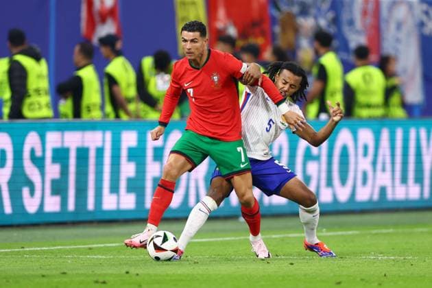 Cristiano Ronaldo of Portugal and Jules Koundà of France Portugal v France, UEFA European Championship, EM, Europameisterschaft 2024, Quarter Final, Football, Volksparkstadion, Hamburg, Germany, 05 Jul 2024 EDITORIAL USE ONLY No use with unauthorised audio, video, data, fixture lists, club league logos or live services. Online in-match use limited to 120 images, no video emulation. No use in betting, games or single club league player publications. Copyright: xKieranxMcManus Shutterstockx 14571382bb