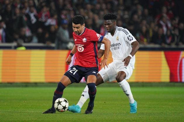 Benjamin Andre of Lille shields the ball from Aurelien Tchouameni of Real Madrid Lille v Real Madrid, UEFA Champions League, Group Stage, Football, Pierre Mauroy Stadium, Lille, France, 02 Oct 2024 EDITORIAL USE ONLY No use with unauthorised audio, video, data, fixture lists, club league logos or live services. Online in-match use limited to 120 images, no video emulation. No use in betting, games or single club league player publications. Copyright: xDavexWinter Shutterstockx 14750773fs