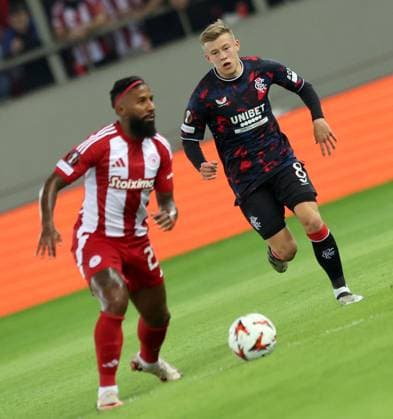 Connor Barron of Rangers and Costinha of Olympiacos during the Europa League group phase match at the Stadio Georgios Karaiskakis, Athens. Olympiakos v Rangers, UEFA Europa League, Group Stage, Football, Georgios Karaiskakis Stadium, Pireas, Greece - 07 Nov 2024 EDITORIAL USE ONLY No use with unauthorised audio, video, data, fixture lists, club league logos or live services. Online in-match use limited to 120 images, no video emulation. No use in betting, games or single club league player publications. Copyright: xLukexNickerson RangersxFC Shutterstockx 14878765bq