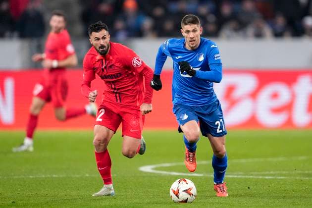 v.li.: Valentin Cretu (FCSB Bukarest, 2), Andrej Kramaric (Hoffenheim, 27), Zweikampf, Spielszene, Duell, duel, tackle, tackling, Dynamik, Action, Aktion, 12.12.2024, Sinsheim (Deutschland), Fussball, UEFA Europa League, Gruppenphase, TSG 1899 Hoffenheim - FCSB Bukarest, REGULATIONS PROHIBIT ANY USE OF PHOTOGRAPHS AS IMAGE SEQUENCES AND OR QUASI-VIDEO. xozx