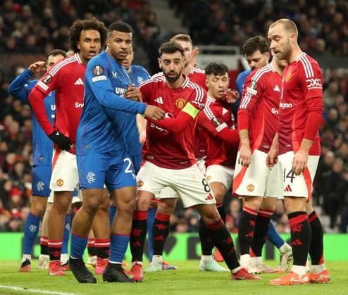 Hamza Igamane of Rangers and Bruno Fernandes of Manchester United, ManU wait for the corner kick during the Europa League group phase match at Old Trafford, Manchester. Manchester United v Rangers, UEFA Europa League, Group Stage, Football, Old Trafford, Manchester, UK - 23 Jan 2025 EDITORIAL USE ONLY No use with unauthorised audio, video, data, fixture lists, club league logos or live services. Online in-match use limited to 120 images, no video emulation. No use in betting, games or single club league player publications. Copyright: xRangersxFC Shutterstockx 15111693fs