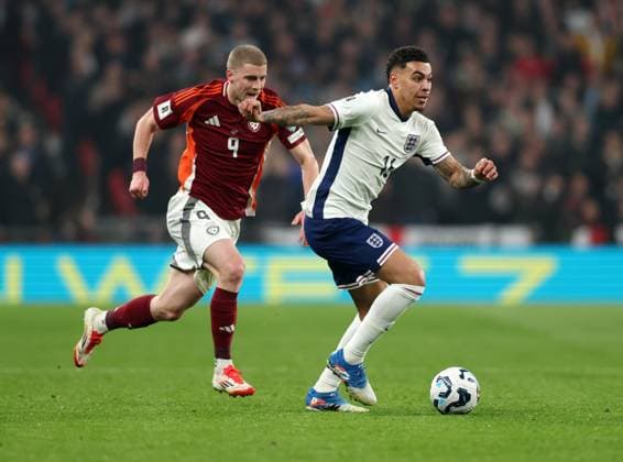 London, England, 24th March 2025. Morgan Rogers of England (r) moves clear of Vladislavs Gutkovskis of Latvia during the FIFA World Cup, WM, Weltmeisterschaft, Fussball European Qualifying match at Wembley Stadium, London. Picture credit should read: David Klein Sportimage EDITORIAL USE ONLY. No use with unauthorised audio, video, data, fixture lists, club league logos or live services. Online in-match use limited to 120 images, no video emulation. No use in betting, games or single club league player publications. SPI_016_DK_England_Latvia SPI-3762-0018