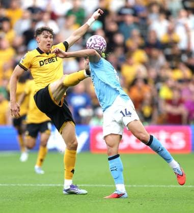 Jörgen Strand Larsen of Wolverhampton Wanderers and Nico Gonzalez of Manchester City in action Wolverhampton Wanderers v Manchester City, Premier League, Football, Molineux, Wolverhampton, UK - 16 Aug 2025Wolverhampton Molineux United Kingdom EDITORIAL USE ONLY No use with unauthorised audio, video, data, fixture lists, club league logos or live services. Online in-match use limited to 120 images, no video emulation. No use in betting, games or single club league player publications. Copyright: xKieranxMcManus Shutterstockx 15444080ac