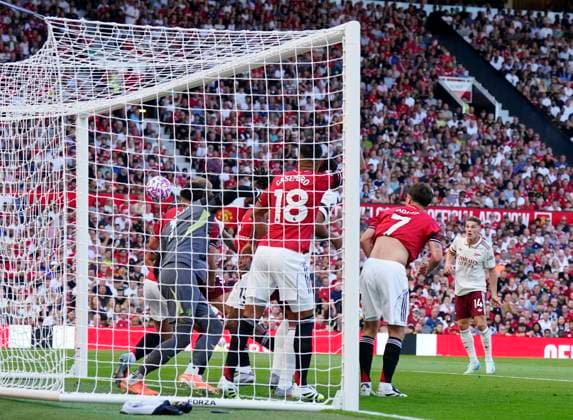 Manchester, England, 17th August 2025. Altay Bayındır of Manchester United, ManU is not strong enough as he lets the ball get through to Riccardo Calafiori of Arsenal who scores the first goal during the Manchester United vs Arsenal Premier League match at Old Trafford, Manchester. Picture credit should read: Andrew Yates Sportimage EDITORIAL USE ONLY. No use with unauthorised audio, video, data, fixture lists, club league logos or live services. Online in-match use limited to 120 images, no video emulation. No use in betting, games or single club league player publications. SPI_029_AY_ManUtd_Arsenal SPI-4072-0042