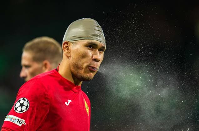 Kairat Almaty goalkeeper Temirlan Anarbekov spits water from his mouth while wearing a rubber cap after receiving treatment for a cut on his head caused in a clash with Shin Yamada of Celtic. Celtic v Kairat Almaty, UEFA Champions League, Play-Off Round, First Leg, Football, Celtic Park, Glasgow, Scotland, UK - 20 Aug 2025Glasgow Celtic Park Scotland United Kingdom EDITORIAL USE ONLY No use with unauthorised audio, video, data, fixture lists, club league logos or live services. Online in-match use limited to 120 images, no video emulation. No use in betting, games or single club league player publications. Copyright: xStuartxWallace Shutterstockx 15446684ba