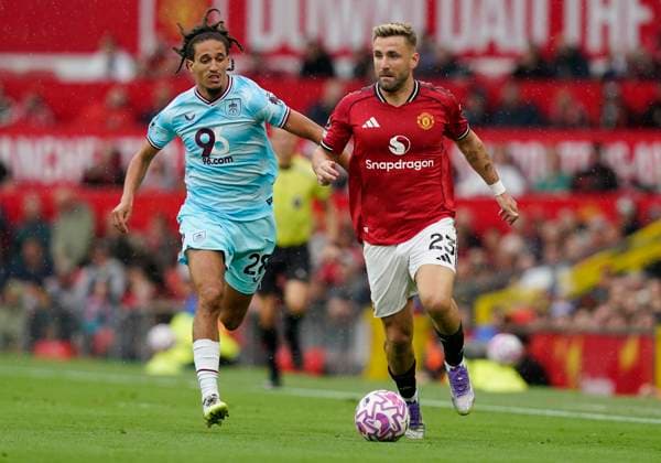 Manchester, England, 30th August 2025. Luke Shaw of Manchester United, ManU (R) is challenged by Hannibal Mejbri of Burnley during the Manchester United vs Burnley Premier League match at Old Trafford, Manchester. Picture credit should read: Andrew Yates Sportimage EDITORIAL USE ONLY. No use with unauthorised audio, video, data, fixture lists, club league logos or live services. Online in-match use limited to 120 images, no video emulation. No use in betting, games or single club league player publications. SPI_015_AY_MANUTD_BURNLEY SPI-4095-0015
