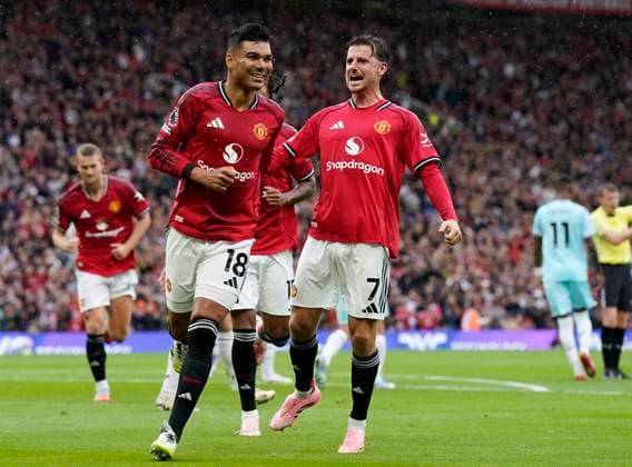 Manchester, England, 30th August 2025. Casemiro of Manchester United, ManU (L) celebrates after scoring the opening goal during the Manchester United vs Burnley Premier League match at Old Trafford, Manchester. Picture credit should read: Andrew Yates Sportimage EDITORIAL USE ONLY. No use with unauthorised audio, video, data, fixture lists, club league logos or live services. Online in-match use limited to 120 images, no video emulation. No use in betting, games or single club league player publications. SPI_018_AY_MANUTD_BURNLEY SPI-4095-0019