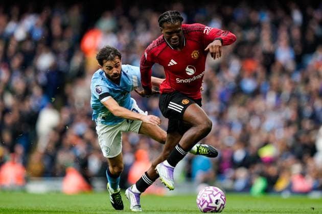 Manchester, England, 14th September 2025. Bernardo Silva of Manchester City fouls Patrick Dorgu of Manchester United, ManU during the Manchester City vs Manchester United Premier League match at the Etihad Stadium, Manchester. Picture credit should read: Andrew Yates Sportimage EDITORIAL USE ONLY. No use with unauthorised audio, video, data, fixture lists, club league logos or live services. Online in-match use limited to 120 images, no video emulation. No use in betting, games or single club league player publications. SPI_019_AY_MCI_MUFC SPI-4139-0019
