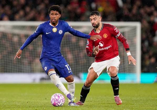 Manchester, England, 20th September 2025. Andrey Santos of Chelsea (L) holds off Bruno Fernandes of Manchester United, ManU during the Manchester United vs Chelsea Premier League match at Old Trafford, Manchester. Picture credit should read: Andrew Yates Sportimage EDITORIAL USE ONLY. No use with unauthorised audio, video, data, fixture lists, club league logos or live services. Online in-match use limited to 120 images, no video emulation. No use in betting, games or single club league player publications. SPI_045_AY_MAN_UTD_CHELSEA SPI-4149-0045