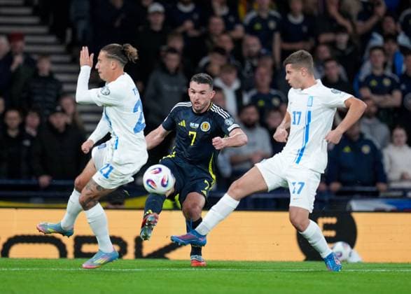 John McGinn of Scotland passes the ball between Kostas Tsimikas & Christos Mouzakitis of Greece. Scotland v Greece, FIFA 2026 World Cup Qualifying, Group C, Football, Hampden Park, Glasgow, Scotland, UK - 09 Oct 2025Glasgow Hampden Park United Kingdom EDITORIAL USE ONLY No use with unauthorised audio, video, data, fixture lists, club league logos or live services. Online in-match use limited to 120 images, no video emulation. No use in betting, games or single club league player publications. Copyright: xStuartxWallace Shutterstockx 15522896er