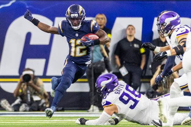 October 23, 2025, Los Angeles, California, USA: Los Angeles Chargers wide receiver Derius Davis 12 escapes a tackle-attempt by Minnesota Vikings outside linebacker Bo Richter 98 during an NFL, American Football Herren, USA football game at SoFi Stadium, Thursday Oct. 23, 2025, in Inglewood, Calif. Los Angeles USA - ZUMAc68_ 20251023_zaf_c68_029 Copyright: xRingoxChiux