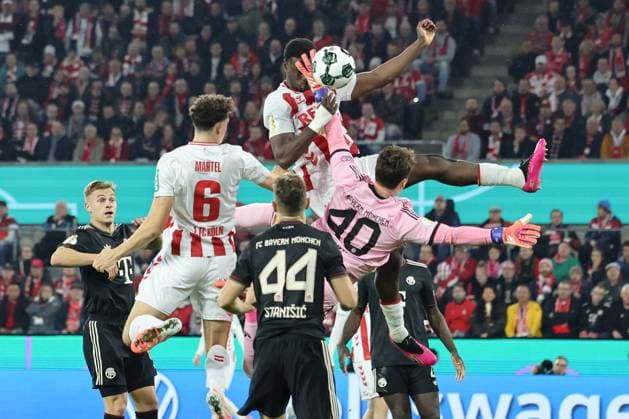 GER, DFB Pokal, 2.Runde, 1. FC Koeln vs. FC Bayern Muenchen 29.10.2025, Rheinenergiestadion, , Koeln, GER, DFB Pokal, 2.Runde, 1. FC Koeln vs. FC Bayern Muenchen, im Bild: Ragnar Ache (FC Koeln 9), versucht den Ball ins Bayerntor zu Köpfen aber Jonas Urbig Torwart (Bayern Muenchen 40), hat die Finger dazwischen