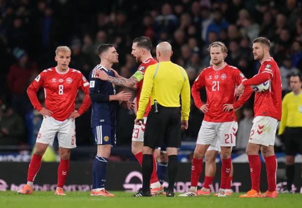 Andy Robertson of Scotland speaks to Pierre-Emile Hojbjerg of Denmark in front of Referee Szymon Marciniak as they wait for VAR review for possible penalty kick to Denmark. Scotland v Denmark, FIFA 2026 World Cup Qualifying, Group C, Football, Hampden Park, Glasgow, Scotland, UK - 18 Nov 2025Glasgow Hampden Park United Kingdom EDITORIAL USE ONLY No use with unauthorised audio, video, data, fixture lists, club league logos or live services. Online in-match use limited to 120 images, no video emulation. No use in betting, games or single club league player publications. Copyright: xStuartxWallace Shutterstockx 15846619af