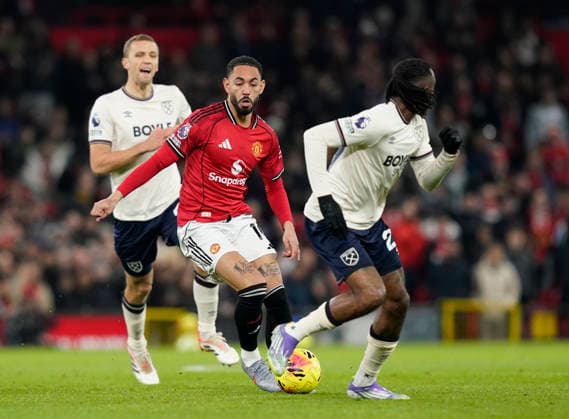 Manchester, England, 4th December 2025. Matheus Cunha of Manchester United, ManU takes on Kyle Walker-Peters of West Ham United during the Manchester United vs West Ham United Premier League match at Old Trafford, Manchester. Picture credit should read: Andrew Yates Sportimage EDITORIAL USE ONLY. No use with unauthorised audio, video, data, fixture lists, club league logos or live services. Online in-match use limited to 120 images, no video emulation. No use in betting, games or single club league player publications. SPI_015_AY_MANUTD_WESTHAM SPI-4345-0016