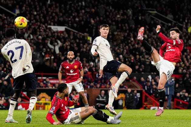 Manchester, England, 4th December 2025. Bruno Fernandes of Manchester United, ManU has a shot at goal during the Manchester United vs West Ham United Premier League match at Old Trafford, Manchester. Picture credit should read: Andrew Yates Sportimage EDITORIAL USE ONLY. No use with unauthorised audio, video, data, fixture lists, club league logos or live services. Online in-match use limited to 120 images, no video emulation. No use in betting, games or single club league player publications. SPI_027_AY_MANUTD_WESTHAM SPI-4345-0028
