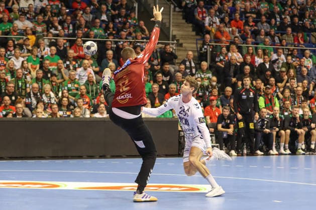 04.12.2025, xtgx, Handball, EHF Champions League, SC Magdeburg - Pick Szeged v.l. Matej Mandic (Magdeburg, 12), Sebastian Frimmel (Szeged, 25) Parade, haelt den Ball, faengt den Ball, pariert Magdeubrg