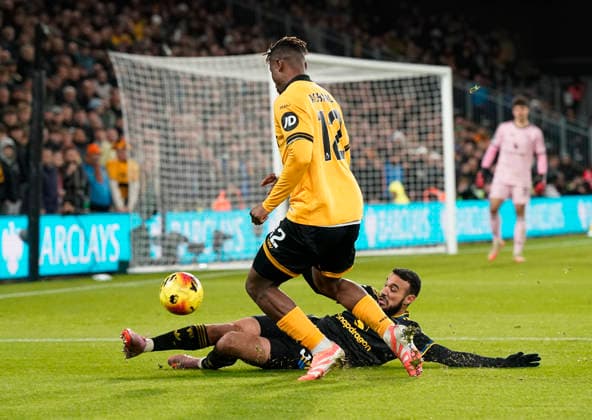 Wolverhampton, England, 8th December 2025. Noussair Mazraoui of Manchester United, ManU tackles Emmanuel Agbadou of Wolverhampton Wanderers during the Wolverhampton Wanderers vs Manchester United Premier League match at Molineux, Wolverhampton. Picture credit should read: Andrew Yates Sportimage EDITORIAL USE ONLY. No use with unauthorised audio, video, data, fixture lists, club league logos or live services. Online in-match use limited to 120 images, no video emulation. No use in betting, games or single club league player publications. SPI_075_AY_Wolves_Man_Utd SPI-4356-0077