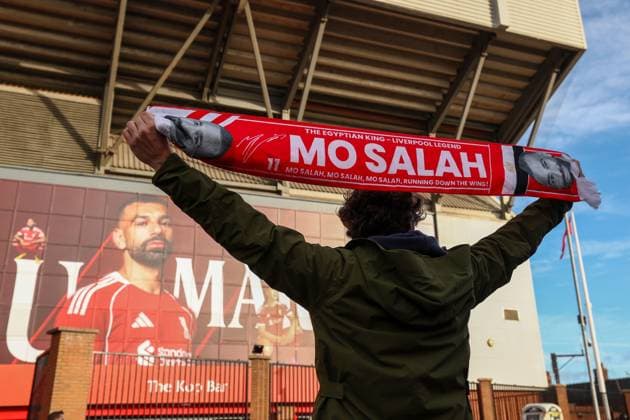 A street vender holds up a scarf of Mohamed Salah of Liverpool Liverpool v Brighton and Hove Albion, Premier League, Football, Anfield, Liverpool, UK - 13 Dec 2025Liverpool Anfield United Kingdom EDITORIAL USE ONLY No use with unauthorised audio, video, data, fixture lists, club league logos or live services. Online in-match use limited to 120 images, no video emulation. No use in betting, games or single club league player publications. Copyright: xRyanxBrowne Shutterstockx 16081506h