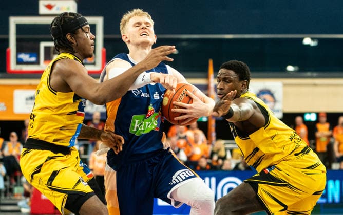 15.12.2025, Basketball, Herren, easy credit BBL, easy credit Bundesliga, BBL, Bundesliga, 10. Spieltag, Rostock Seawolves - MHP Riesen Ludwigsburg Åukasz Kolenda (Rostock Seawolves, Mitte) gegen Stefan Smith (MHP Riesen Ludwigsburg, li.) und Babacar Sane (MHP Riesen Ludwigsburg, re.) Rostock Stadthalle Mecklenburg-Vorpommern Deutschland