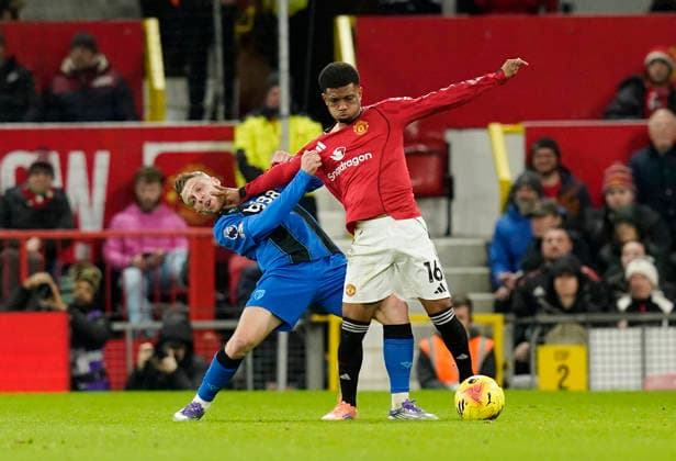 Manchester, England, 15th December 2025. Adrien Truffert of Bournemouth held off by Amad Diallo of Manchester United, ManU during the Manchester United vs AFC Bournemouth Premier League match at Old Trafford, Manchester. Picture credit should read: Andrew Yates Sportimage EDITORIAL USE ONLY. No use with unauthorised audio, video, data, fixture lists, club league logos or live services. Online in-match use limited to 120 images, no video emulation. No use in betting, games or single club league player publications. SPI_033_AY_Man_Utd_Bmouth SPI-4379-0033