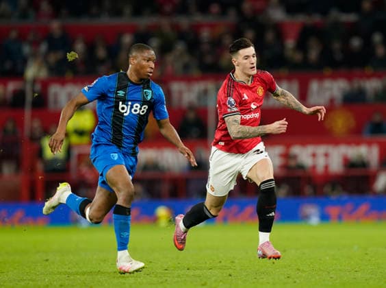 Manchester, England, 15th December 2025. Bafode Diakite of Bournemouth tussles with Tyler Fredricson of Manchester United, ManU during the Manchester United vs AFC Bournemouth Premier League match at Old Trafford, Manchester. Picture credit should read: Andrew Yates Sportimage EDITORIAL USE ONLY. No use with unauthorised audio, video, data, fixture lists, club league logos or live services. Online in-match use limited to 120 images, no video emulation. No use in betting, games or single club league player publications. SPI_074_AY_Man_Utd_Bmouth SPI-4379-0074