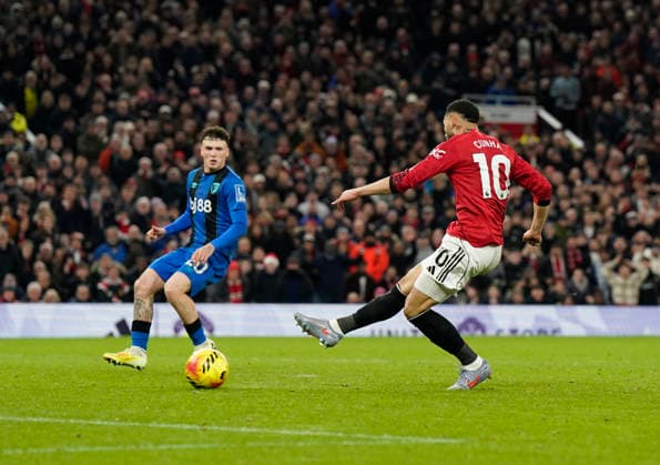 Manchester, England, 15th December 2025. Matheus Cunha of Manchester United, ManU scores the fourth goal during the Manchester United vs AFC Bournemouth Premier League match at Old Trafford, Manchester. Picture credit should read: Andrew Yates Sportimage EDITORIAL USE ONLY. No use with unauthorised audio, video, data, fixture lists, club league logos or live services. Online in-match use limited to 120 images, no video emulation. No use in betting, games or single club league player publications. SPI_085_AY_Man_Utd_Bmouth SPI-4379-0086