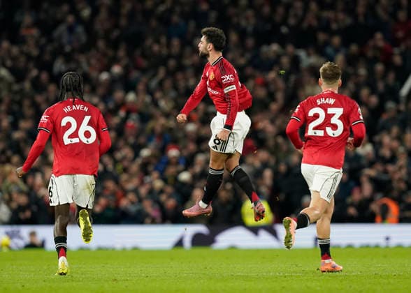 Manchester, England, 15th December 2025. Bruno Fernandes of Manchester United, ManU celebrates scoring their third goal during the Manchester United vs AFC Bournemouth Premier League match at Old Trafford, Manchester. Picture credit should read: Andrew Yates Sportimage EDITORIAL USE ONLY. No use with unauthorised audio, video, data, fixture lists, club league logos or live services. Online in-match use limited to 120 images, no video emulation. No use in betting, games or single club league player publications. SPI_090_AY_Man_Utd_Bmouth SPI-4379-0091