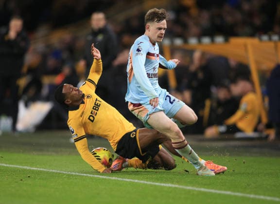 Jackson Tchatchoua of Wolverhampton Wanderers (L) tackles Keane Lewis-Potter of Brentford. Wolverhampton Wanderers v Brentford, Premier League, Football, Molineux, Wolverhampton, UK - 20 Dec 2025Wolverhampton Molineux United Kingdom EDITORIAL USE ONLY No use with unauthorised audio, video, data, fixture lists, club league logos or live services. Online in-match use limited to 120 images, no video emulation. No use in betting, games or single club league player publications. Copyright: xLindseyxParnaby Shutterstockx 16148976bb