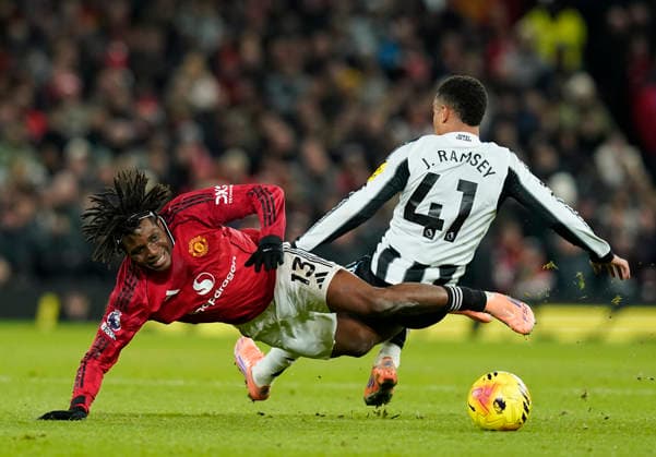 Manchester, England, 26th December 2025. Patrick Dorgu of Manchester United, ManU (L) is challenged by Jacob Ramsey of Newcastle United during the Manchester United vs Newcastle United Premier League match at Old Trafford, Manchester. Picture credit should read: Andrew Yates Sportimage EDITORIAL USE ONLY. No use with unauthorised audio, video, data, fixture lists, club league logos or live services. Online in-match use limited to 120 images, no video emulation. No use in betting, games or single club league player publications. SPI_014_AY_MAN_UTD_NEWC SPI-4393-0014