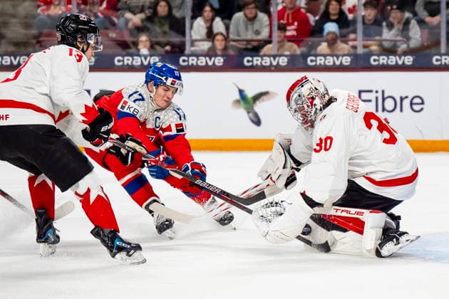 December 26, 2025, Minneapolis, Mn, Canada: Canada goaltender Carter George (30) makes a save on Czechia s Petr Sikora (17) while Canada s Ethan MacKenzie (13) defends, during first period IIHF World Junior Championship hockey action, in Minneapolis, Friday, Dec. 26, 2025. Canada News - December 26, 2025 - ZUMAc35_ 20251226_zaf_c35_086 Copyright: xChristopherxKatsarovx